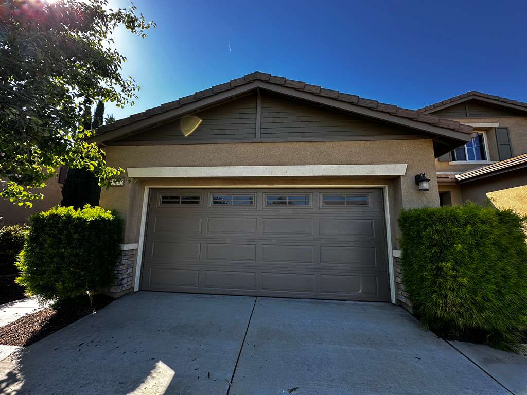 Painted garage door and clean exterior detail — Riverside, CA