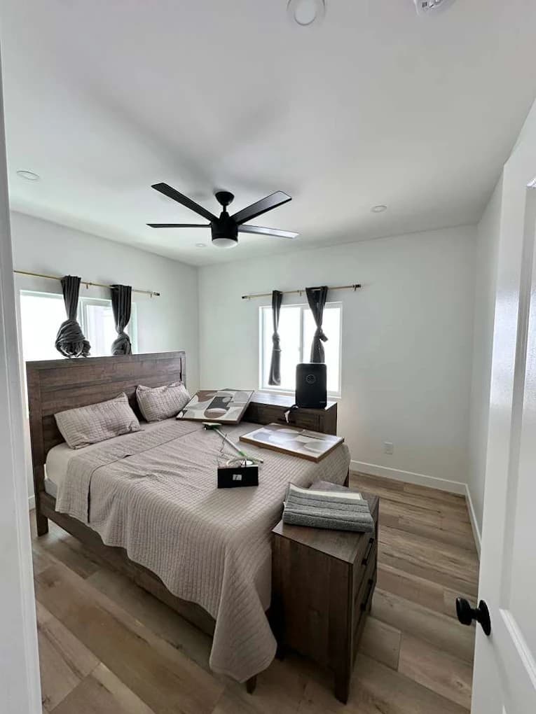 Master bedroom repaint with crisp baseboards and accent wall