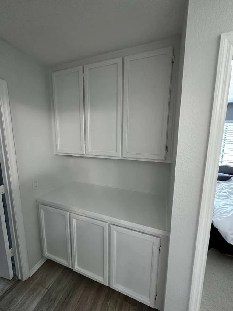Refinished white kitchen cabinets by CM Painters