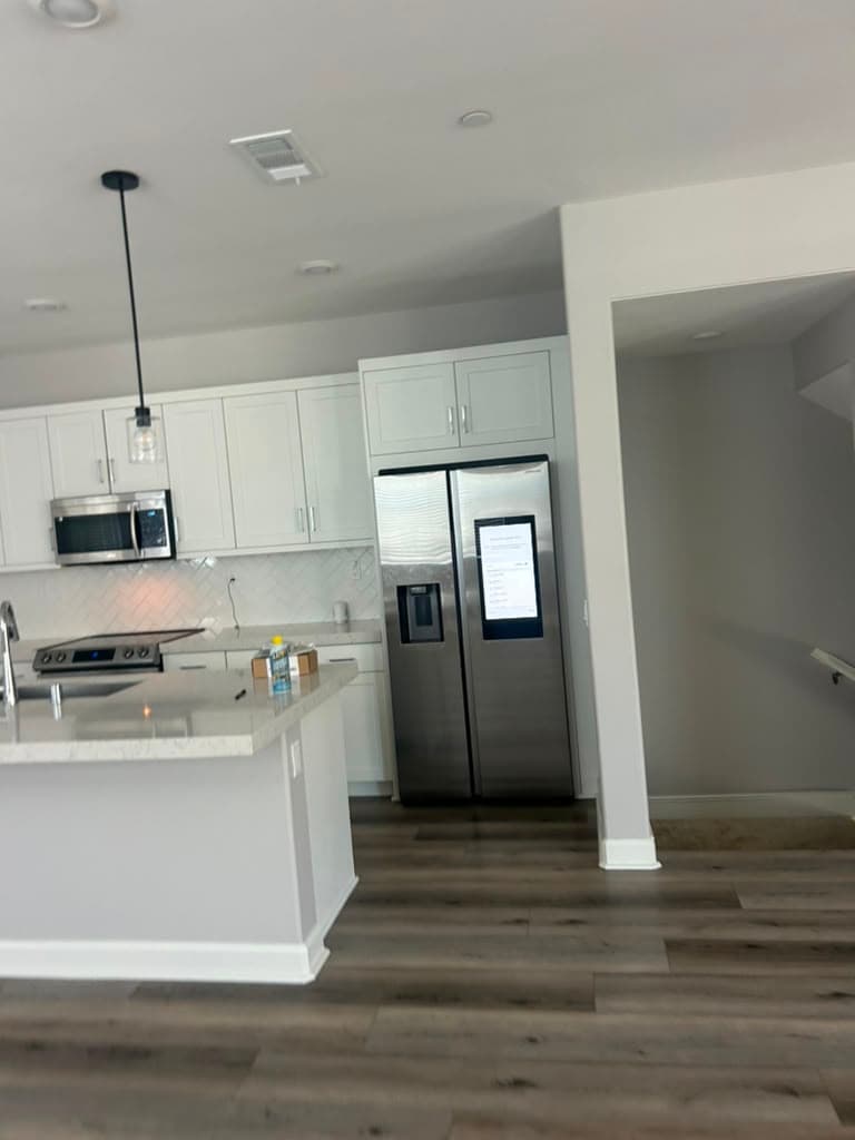 Freshly painted kitchen with smooth walls and clean trim by the stair landing — Riverside, CA